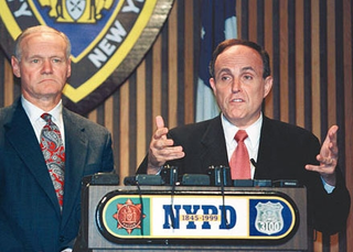 New York mayor Rudolph Giuliani, flanked by police commissioner
Howard Safir, fields reporters' questions about the accidental killing of
a Jamaican immigrant by 27 NYPD officers.